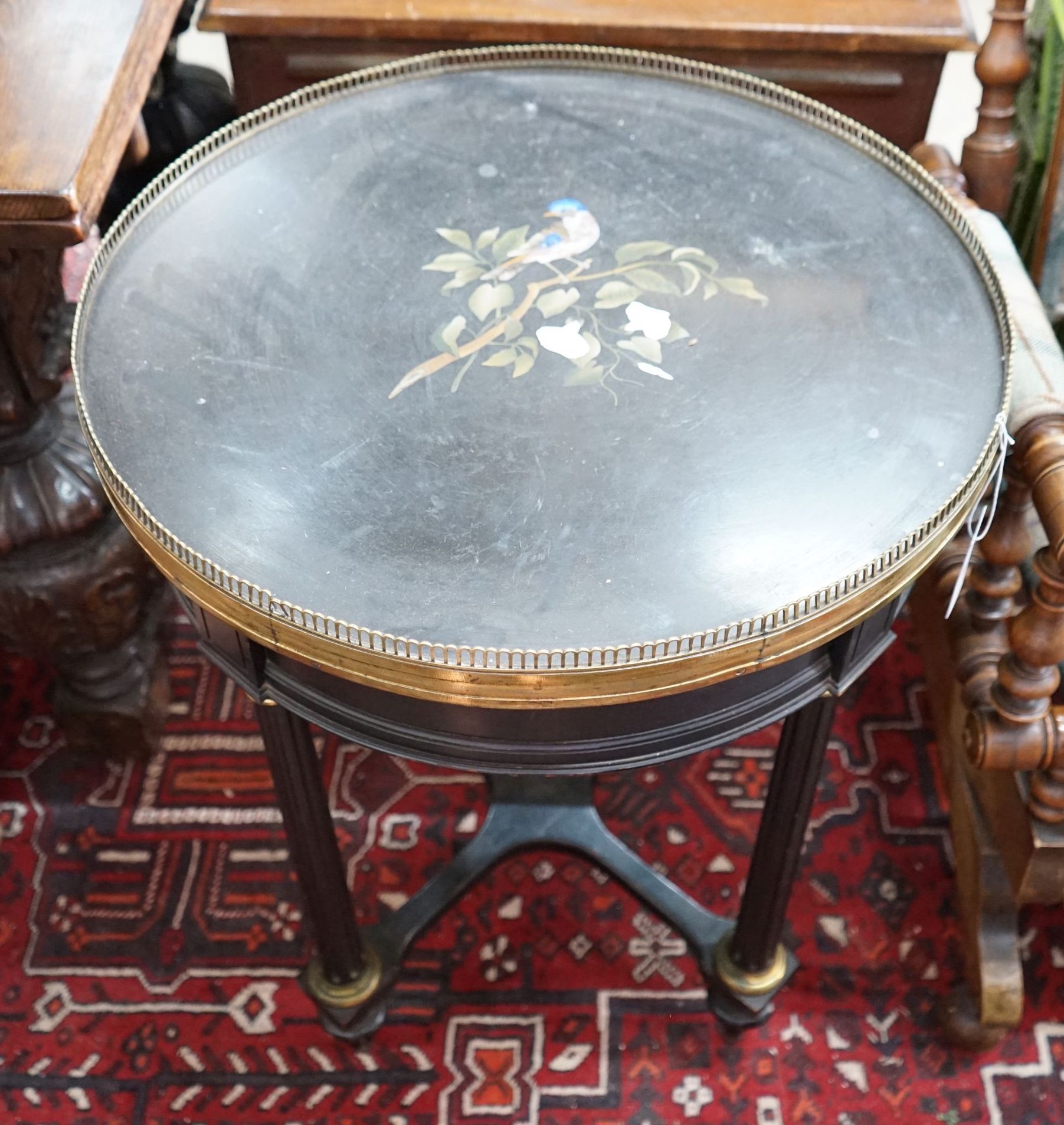 A Victorian circular gilt metal mounted ebonised centre table with pietra dura top, diameter 57cm, height 74cm
